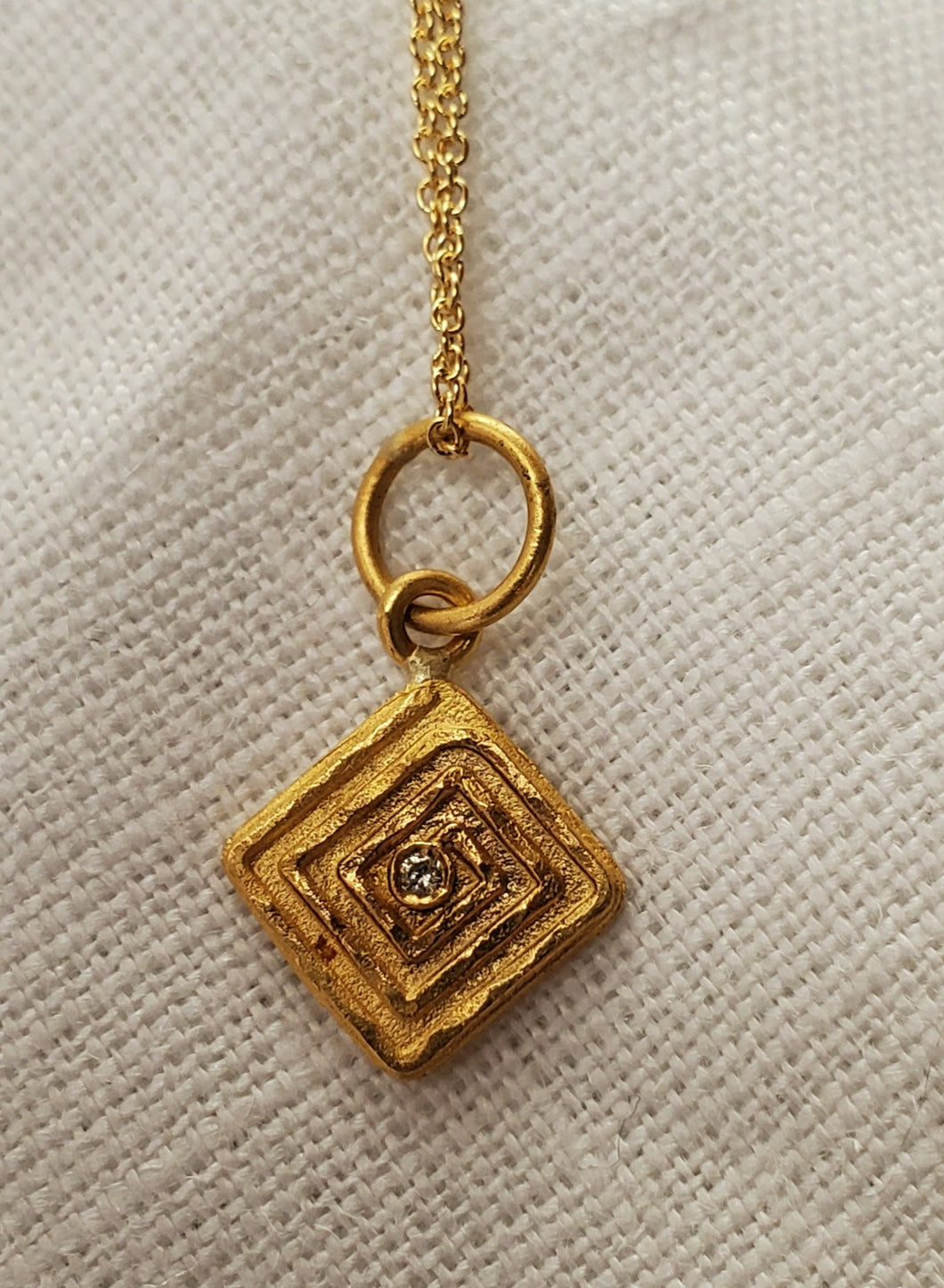 Prehistoric Works 24K Gold pendant w/diamond